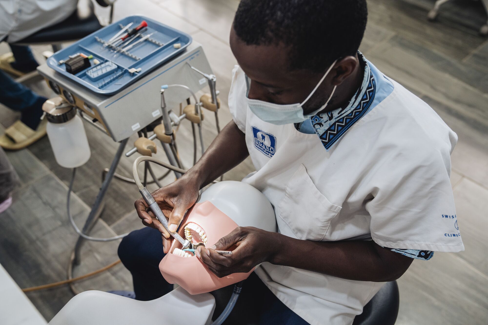 A UGANC Dental Student practices skills using donated simulation equipment.