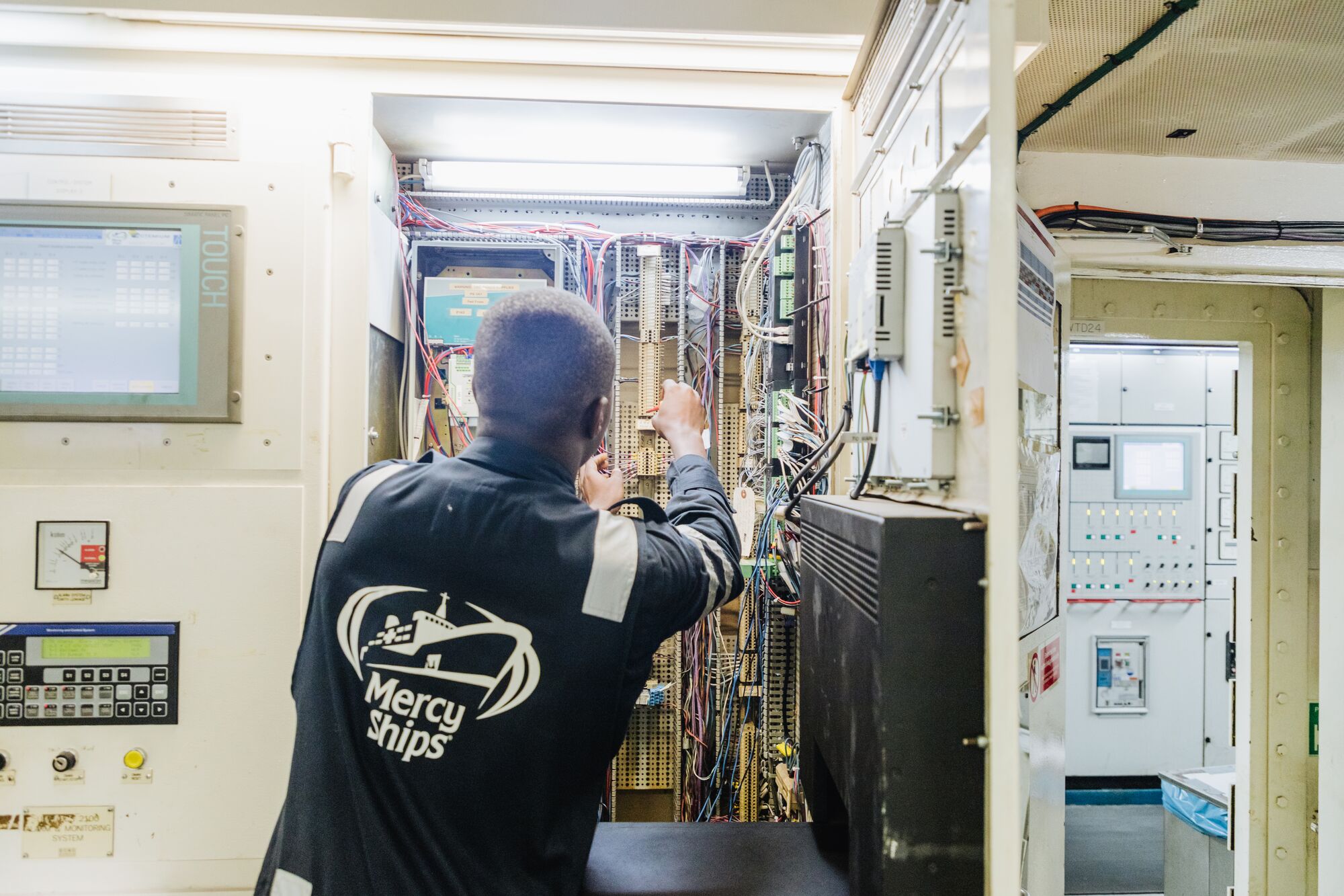 Behind the operating rooms, Jean Jacques and the engineering team maintain the electrical systems that keep the ship running, helping create a safe environment where medical teams can care for patients.